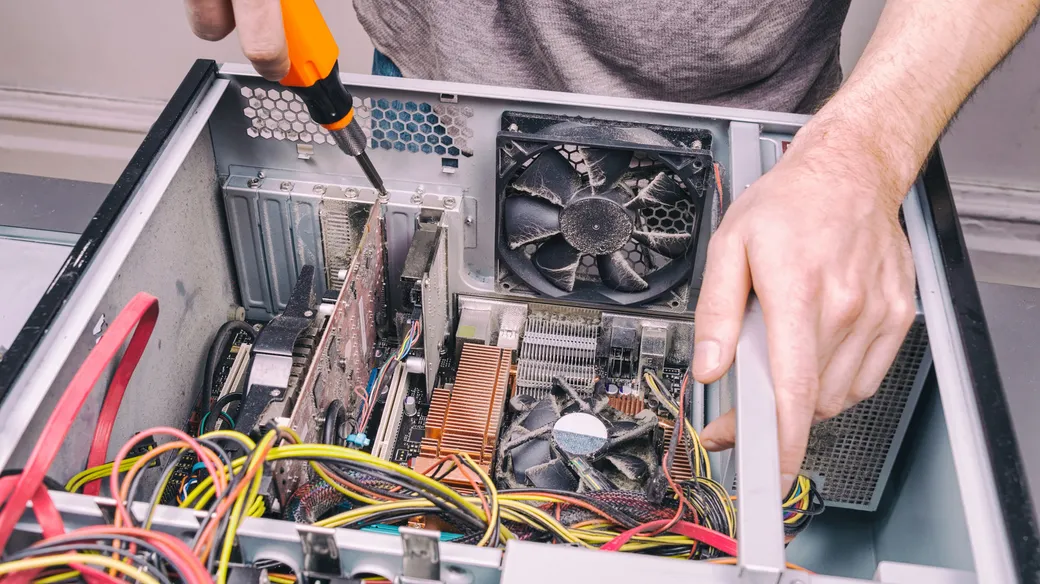 An electronics repair workbench with hand tools and equipment