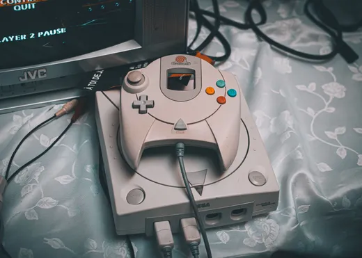 A used game console with a controller and cables