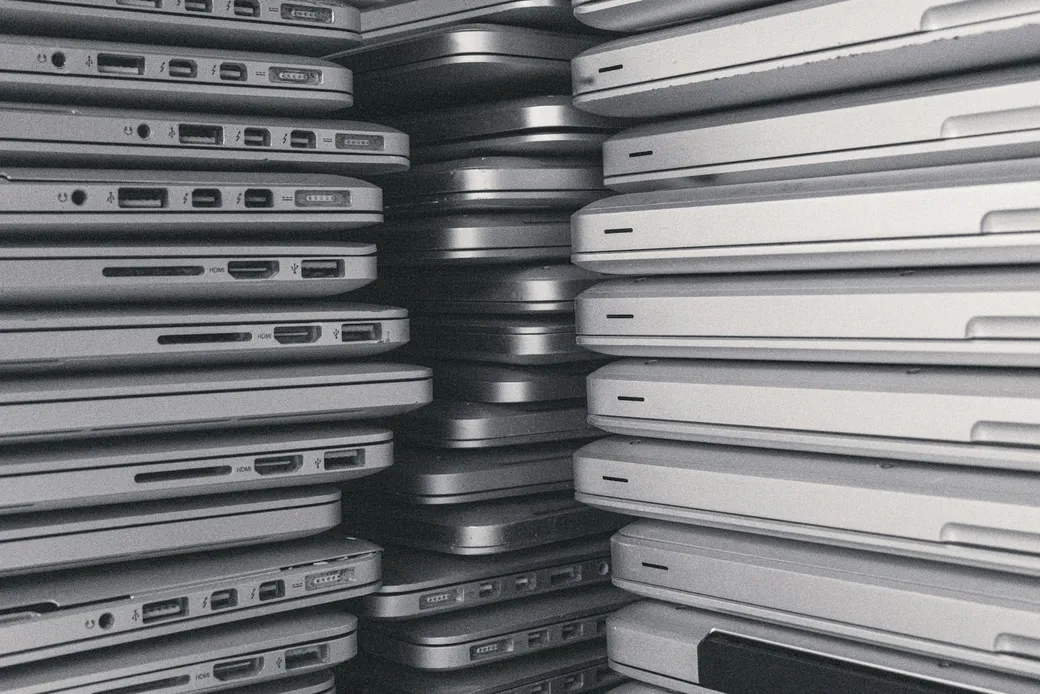 Stacks of used laptops collected from an office