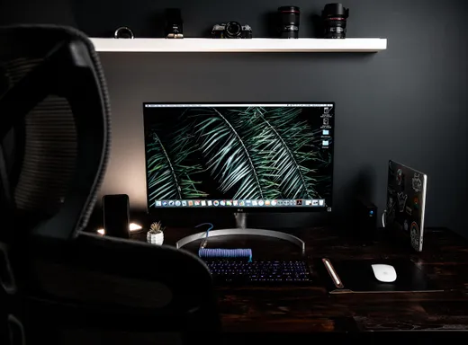 A flat-panel monitor and peripherals on a desk