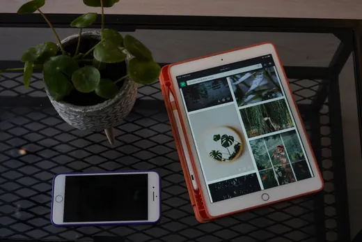 A phone and tablet on a metal surface
